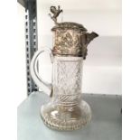 A silver plated Continental cut glass Claret jug decorated with cherubs (af).