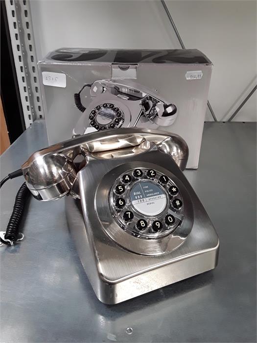 A modern reproduction push button telephone in the 1960's rotary style with box.