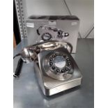 A modern reproduction push button telephone in the 1960's rotary style with box.