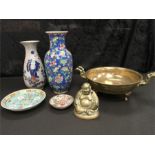 A heavy brass Oriental bowl with elephant head handles and feet, a brass Buddha two vases and two