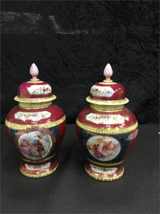 A pair of Vienna style lidded urns with decorative cartouches. 8.5" high.