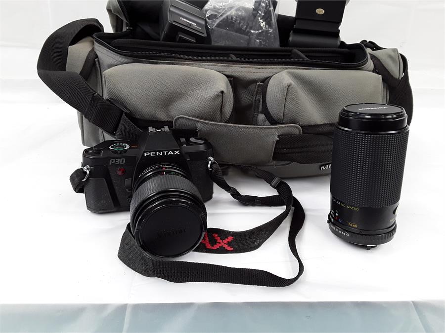 A camera case containing a Pentax camera with a Vivitar lens together with a Miranda lens.