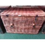 A large wicker laundry basket.