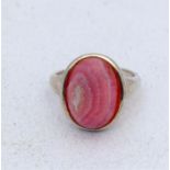 A silver set fashion ring with red eye stone, size P.