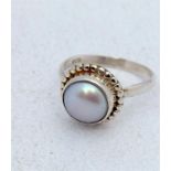 A silver and Mother of Pearl set fashion ring.