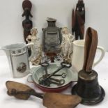 A collection of various collectables to include brass bell, vintage clock keys, oil lamp, African