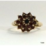 A 9 carat gold ladies' antique garnet cluster ring, size N.