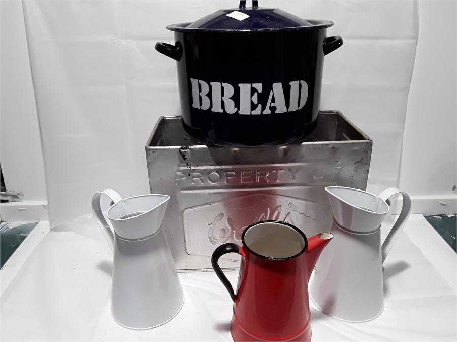 A metal Wall's ice-cream container together with two enamel jugs and coffee pot.