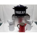 A metal Wall's ice-cream container together with two enamel jugs and coffee pot.