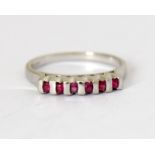 A 9 carat white gold ruby bar ring, size N.