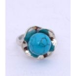 A silver and turquoise ring, size R.