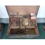 A carpenter's vintage toolbox together with woodworking tools.