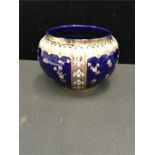 A cobalt blue jardiniere decorated with gilding and enamel (6.5" high).