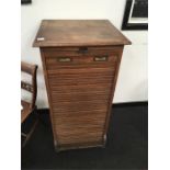 An Edwardian oak tambour fronted filing cabinet with brass handles and key made by MSCUS Saint James