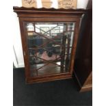 A reproduction Chippendale design astragal glazed wall display cabinet with mirror back.