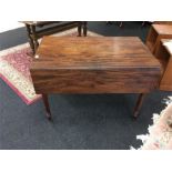 A 19th century Pembroke table in mahogany, resting on turned supports.