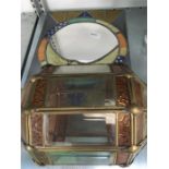 A stained glass mirror together with a glass lamp shade.