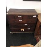 A Georgian oak chest of two short and three long graduated drawers resting on bun feet with brass