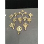 Eleven old horse brasses/plumes (swingers), one triple and ten singles of various design.