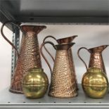 Four copper jugs with two brass tea caddies.
