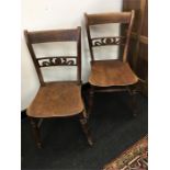 A pair of Victorian elm and beach Mendlesham kitchen chairs with carved fretted backs.