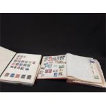 Two large stamp albums containing stamps from various countries.