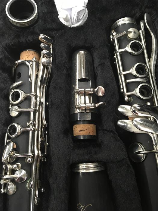 A Vivace clarinet in a grey case.