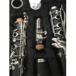 A Vivace clarinet in a grey case.