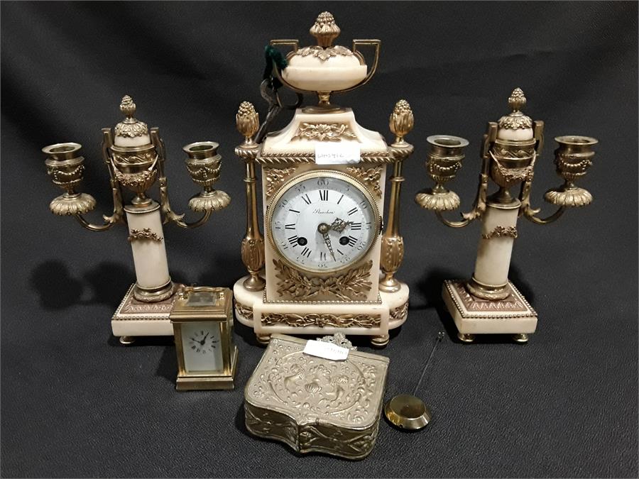 A French style marble mantle clock with brass decoration together with two matching candlesticks,