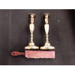 A pair of brass candlesticks barbers strop.