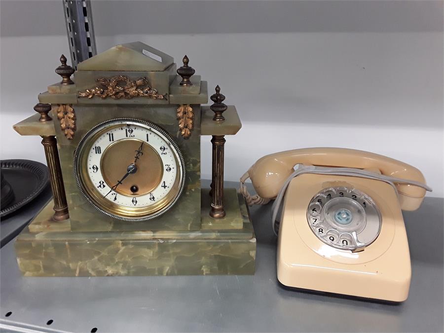 A green marble mantle clock together with a retro rotary telephone.