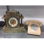 A green marble mantle clock together with a retro rotary telephone.