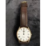 A 9ct gold Gents Longines watch in original case with extra strap.