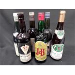 Six vintage bottles of various alcohol.