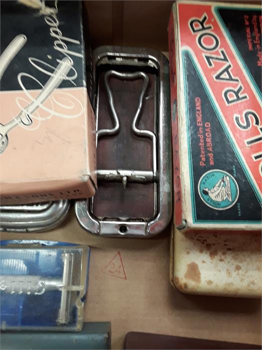 A box of vintage razors and razor blades together with a box of picnic trays for the car.