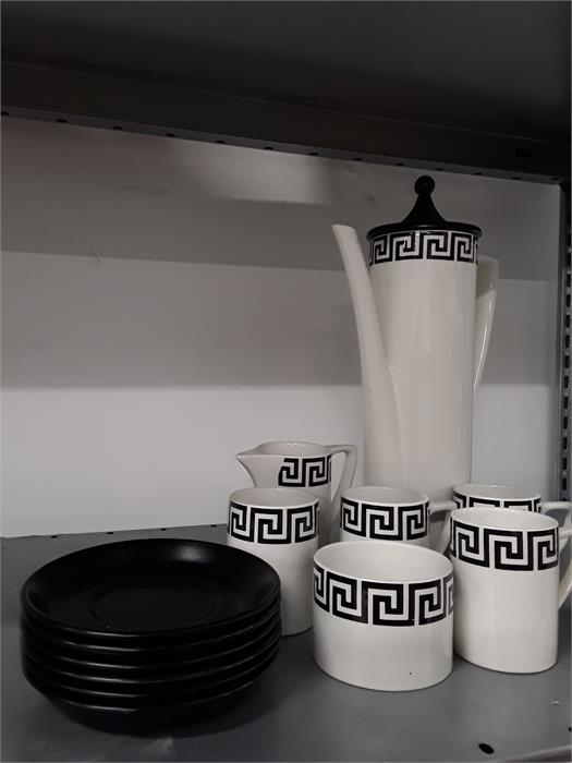 The residue of a black and white geometric Portmeirion coffee set. One cup handle broken off.