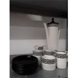 The residue of a black and white geometric Portmeirion coffee set. One cup handle broken off.