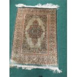 A signed Hereke Silk Carpet. ( 80cm x 120cm).