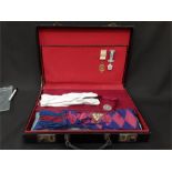 A leather case full of Masonic medals, clothing etc.