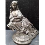 A bronzed figure of a lady holding mascarade. Limited edition 17/500.