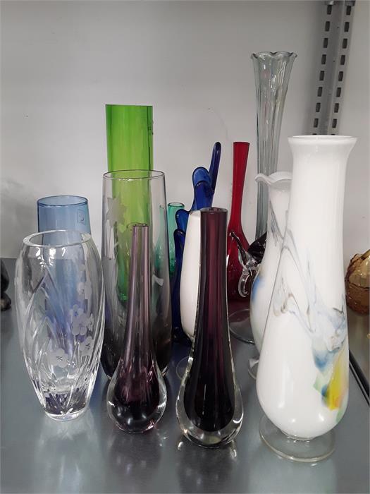 Fourteen various coloured glass vases.