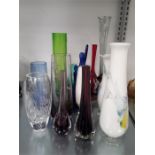 Fourteen various coloured glass vases.