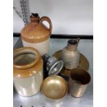 Two stoneware jugs together with some brass.