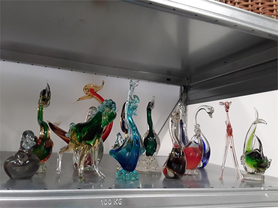 A large quantity of coloured glass animals. Mainly swans.