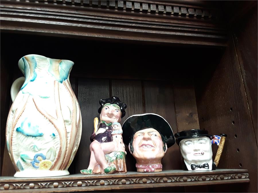 Three Toby jugs and a piece of pottery to include Winston Churchill.