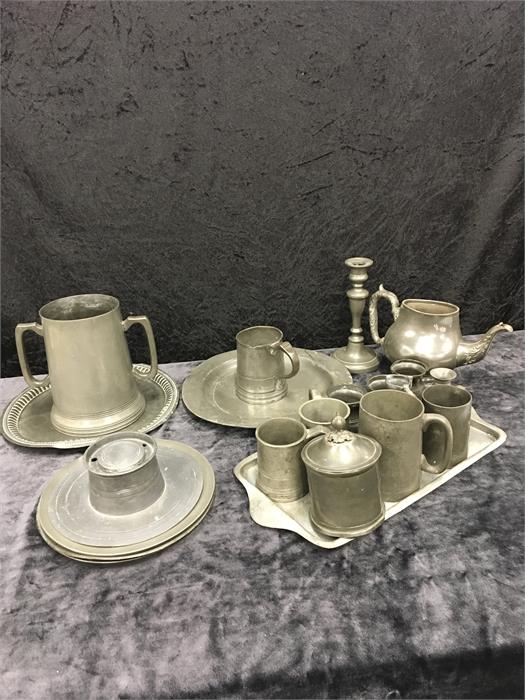 A mixed lot of pewter including tankards, an inkwell, plates, etc.