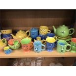 A colourful collection of teapots, cups and bowls.