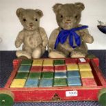 Two teddy bears and a Tri-ang wooden block trolley.