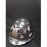 A vintage chrome American Helmet with badges and fitted inside from Berlin in the 70s