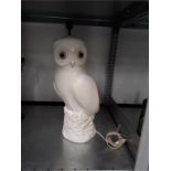 An off white coloured lamp base depicting an owl.